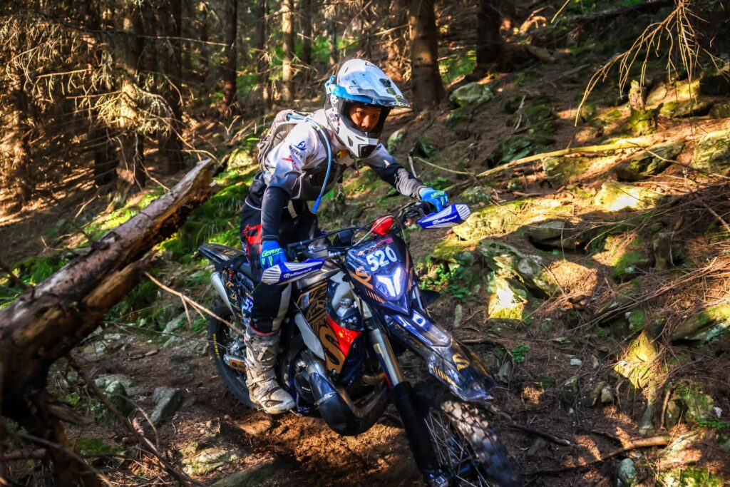 Yang Songyi riding a production-based TAIMU S300R through a forest section in Romania